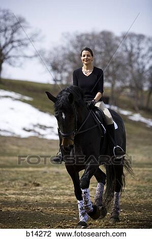 Woman riding horse View Large Photo Image Stock Image - Woman riding horse. Fotosearch