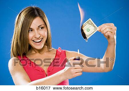 Woman setting American one dollar bill on fire View Large Photo Image Stock Photo - Woman setting American one dollar bill on fire. Fotosearch