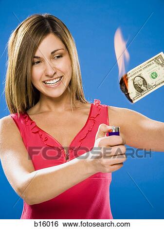 Woman setting American one dollar bill on fire View Large Photo Image Stock Photograph - Woman setting American one dollar bill on fire. Fotosearch