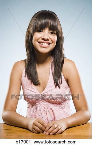 Woman sitting at desk smiling View Large Photo Image Stock Image - Woman sitting at desk smiling. Fotosearch