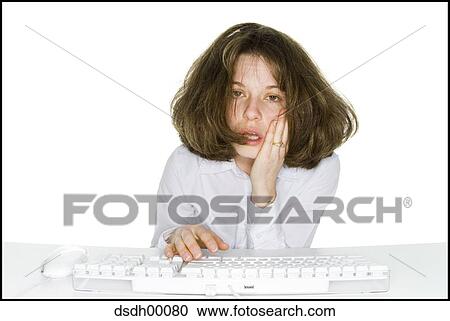 Woman sitting at keyboard with head in hand View Large Photo Image Stock Image - Woman sitting at keyboard with head in hand. Fotosearch