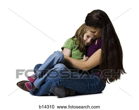 Stock Image - Woman sitting cross legged with girl. Fotosearch