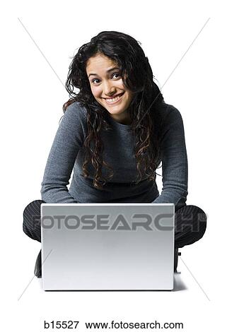 Woman sitting cross legged with laptop smiling View Large Photo Image Stock Photo - Woman sitting cross legged with laptop smiling. Fotosearch