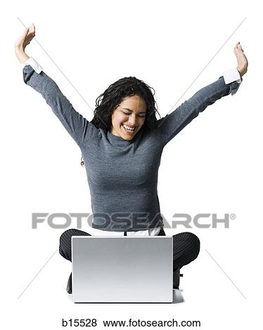 Woman sitting cross legged with laptop stretching View Large Photo Image Stock Photo - Woman sitting cross legged with laptop stretching. Fotosearch