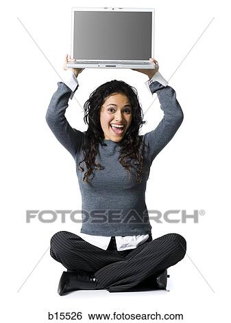 Woman sitting cross legged with laptop smiling View Large Photo Image Stock Photograph - Woman sitting cross legged with laptop smiling. Fotosearch