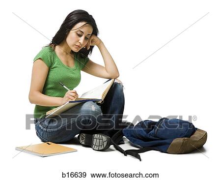 Woman sitting cross legged with backpack doing homework View Large Photo Image Stock Photo - Woman sitting cross legged with backpack doing homework. Fotosearch