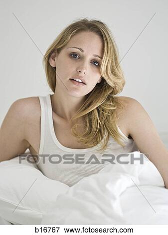 Woman sitting in bed View Large Photo Image Stock Photo - Woman sitting in bed. Fotosearch