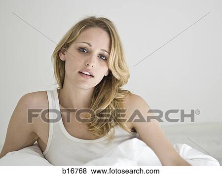 Woman sitting in bed View Large Photo Image Stock Photo - Woman sitting in bed. Fotosearch
