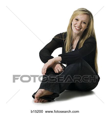 Woman sitting listening to mp3 player View Large Photo Image Stock Image - Woman sitting listening to mp3 player. Fotosearch