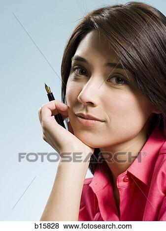 Stock Photo - Woman sitting with fountain pen. Fotosearch