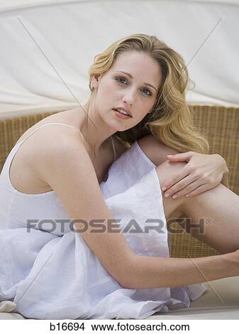 Woman sitting with knees up View Large Photo Image Picture - Woman sitting with knees up. Fotosearch
