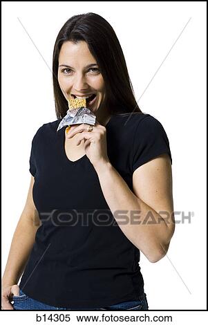 Stock Photography - Woman smiling and eating.. Fotosearch