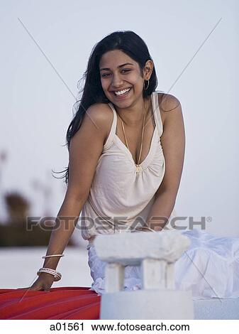 Woman smiling and leaning outdoors View Large Photo Image Stock Image - Woman smiling and leaning outdoors. Fotosearch