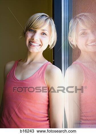 Woman smiling and leaning with reflection View Large Photo Image Stock Image - Woman smiling and leaning with reflection. Fotosearch