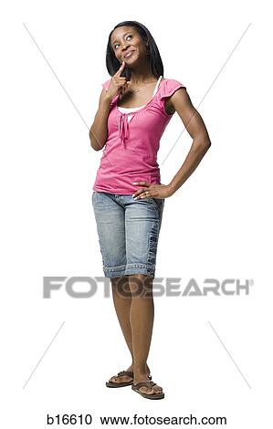 Stock Image - Woman standing and thinking. Fotosearch