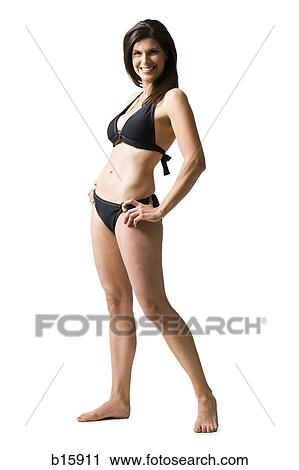 Woman standing in bikini with hands on hips smiling View Large Photo Image Stock Image - Woman standing in bikini with hands on hips smiling. Fotosearch