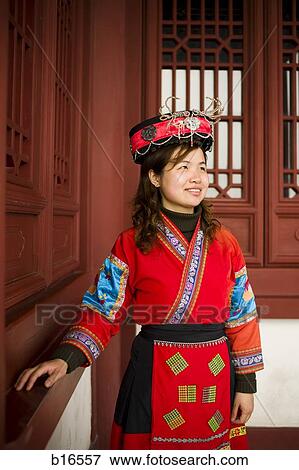 Woman standing in traditional dress with hat smiling View Large Photo Image Stock Photo - Woman standing in traditional dress with hat smiling. Fotosearch