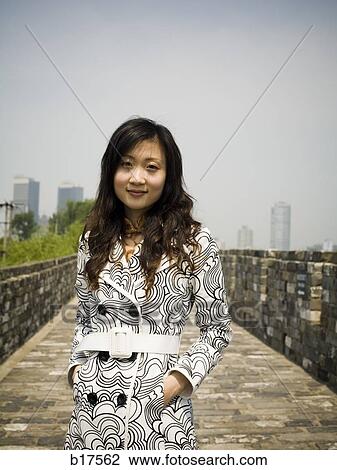 Woman standing on stone bridge smiling View Large Photo Image Stock Image - Woman standing on stone bridge smiling. Fotosearch