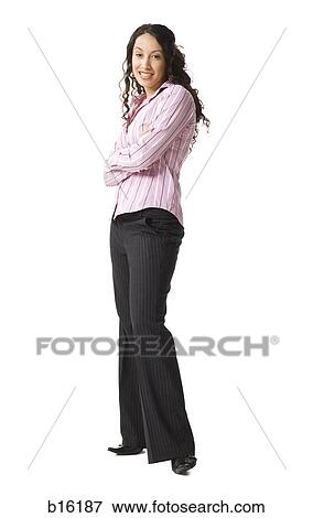 Stock Photo - Woman standing with arms crossed. Fotosearch