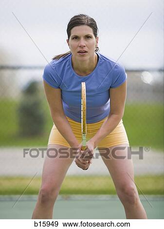 Woman standing with tennis racquet View Large Photo Image Stock Photo - Woman standing with tennis racquet. Fotosearch