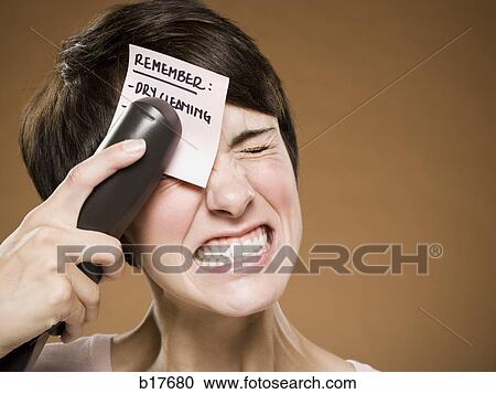 Woman stapling list of things to remember to her forehead and wincing View Large Photo Image Stock Image - Woman stapling list of things to remember to her forehead and wincing. Fotosearch
