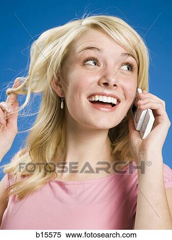 Woman talking on cell phone smiling View Large Photo Image Stock Photography - Woman talking on cell phone smiling. Fotosearch
