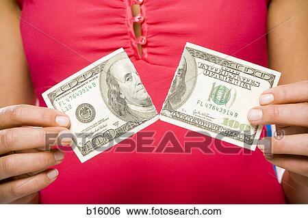 Woman tearing American hundred dollar bill View Large Photo Image Stock Photograph - Woman tearing American hundred dollar bill. Fotosearch