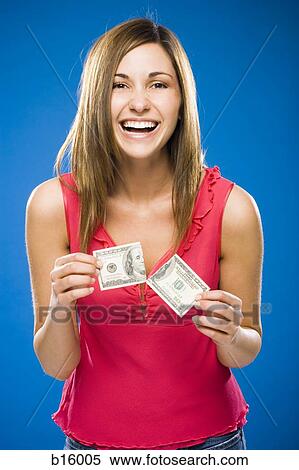Woman tearing American hundred dollar bill smiling View Large Photo Image Stock Photography - Woman tearing American hundred dollar bill smiling. Fotosearch