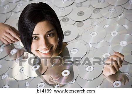 Woman up to kneck in DVDs View Large Photo Image Stock Photo - Woman up to kneck in DVDs. Fotosearch