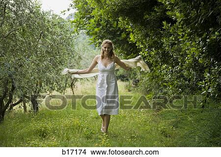 Woman walking in woods and smiling View Large Photo Image Picture - Woman walking in woods and smiling. Fotosearch