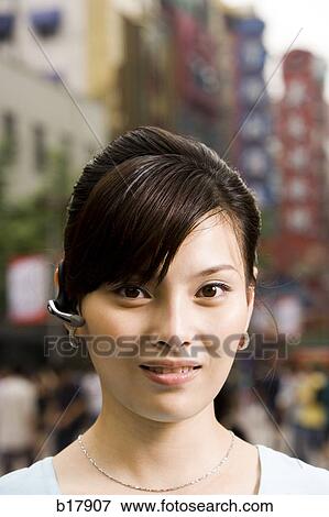 Woman with a cell phone earpiece. View Large Photo Image Stock Photo - Woman with a cell phone earpiece.. Fotosearch