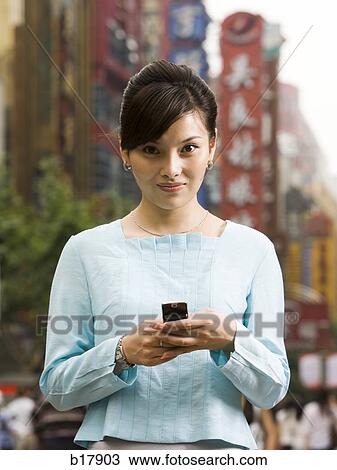 Woman with a cell phone. View Large Photo Image Stock Image - Woman with a cell phone.. Fotosearch