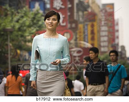 Stock Image - Woman with an mp3 player.. Fotosearch
