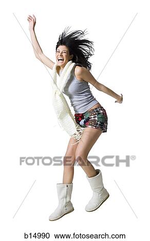 Stock Image - Woman with bare legs and boots dancing. Fotosearch