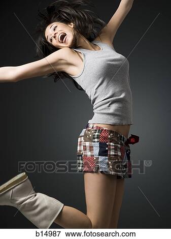 Stock Photo - Woman with bare legs and boots dancing. Fotosearch