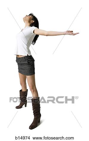 Picture - Woman with bare legs and boots stretching. Fotosearch