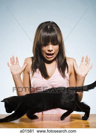 Woman with black kitten scared View Large Photo Image Stock Image - Woman with black kitten scared. Fotosearch