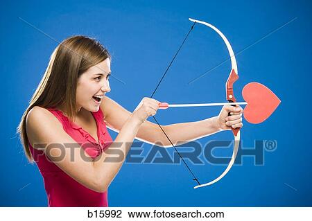 Woman with bow and arrow with heart View Large Photo Image Stock Image - Woman with bow and arrow with heart. Fotosearch