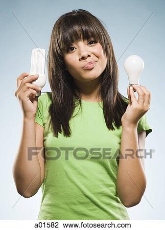 Woman with fluorescent and incandescent light bulbs View Large Photo Image Stock Image - Woman with fluorescent and incandescent light bulbs. Fotosearch