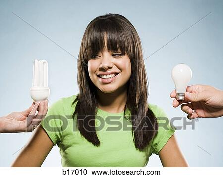 Woman with fluorescent and incandescent light bulbs View Large Photo Image Stock Image - Woman with fluorescent and incandescent light bulbs. Fotosearch