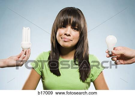 Woman with fluorescent and incandescent light bulbs View Large Photo Image Stock Photo - Woman with fluorescent and incandescent light bulbs. Fotosearch