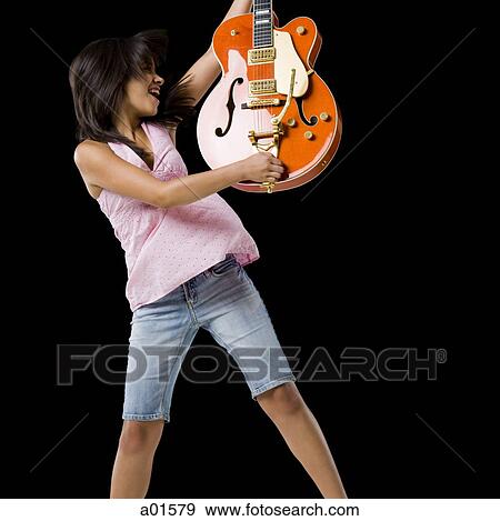 Woman with guitar smiling and dancing View Large Photo Image Stock Photo - Woman with guitar smiling and dancing. Fotosearch