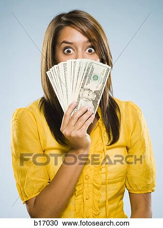 Woman with handful of money View Large Photo Image Stock Image - Woman with handful of money. Fotosearch