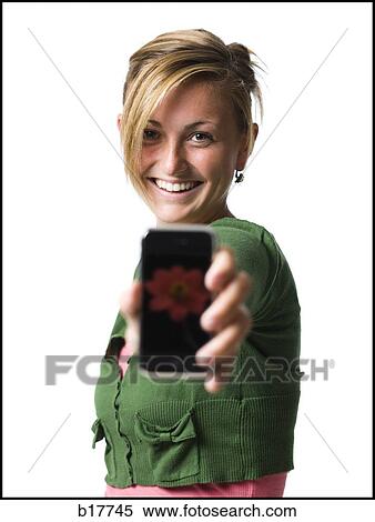 Woman with handheld electronic device smiling View Large Photo Image Stock Photography - Woman with handheld electronic device smiling. Fotosearch