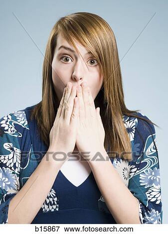 Woman with hands covering mouth surprised View Large Photo Image Stock Photo - Woman with hands covering mouth surprised. Fotosearch