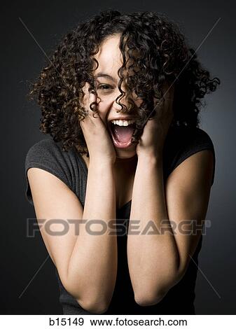 Woman with hands on face and mouth open View Large Photo Image Stock Photo - Woman with hands on face and mouth open. Fotosearch