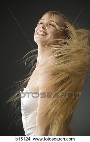 Woman with long blonde hair standing View Large Photo Image Picture - Woman with long blonde hair standing. Fotosearch