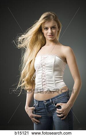 Woman with long blonde hair standing View Large Photo Image Stock Image - Woman with long blonde hair standing. Fotosearch