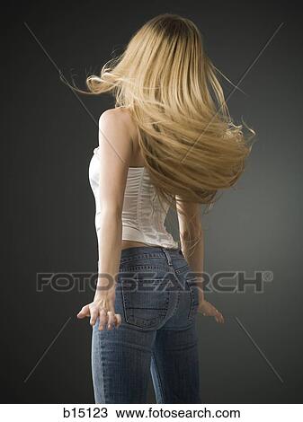 Woman with long blonde hair standing rear view View Large Photo Image Stock Image - Woman with long blonde hair standing rear view. Fotosearch