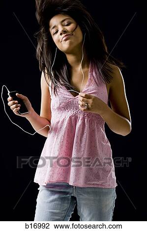 Woman with mp3 player dancing and smiling View Large Photo Image Stock Image - Woman with mp3 player dancing and smiling. Fotosearch